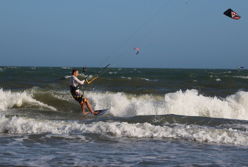 International tourists kite surfing on Mui Ne beach