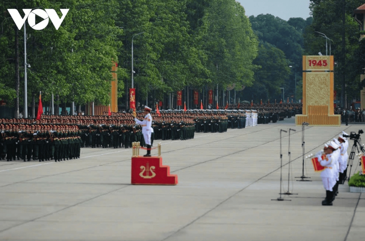 The formations march in unison in military music as they enter Ba Dinh Square