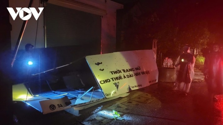 Tin roofs of homes are blown off and fall onto the road