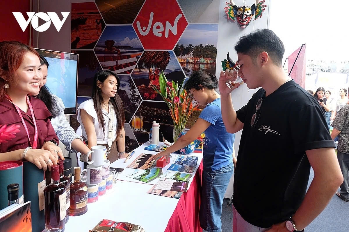 Visitors sample rum made from molasses at the booth of the Embassy of Venezuela.