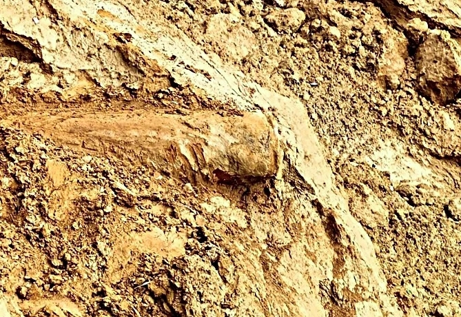 The bomb has been found exposed on the riverbank