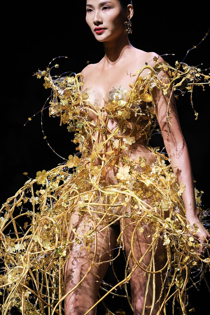 The gold leaf outfit is adorned with hundreds of hand-cut, 3D flowers.