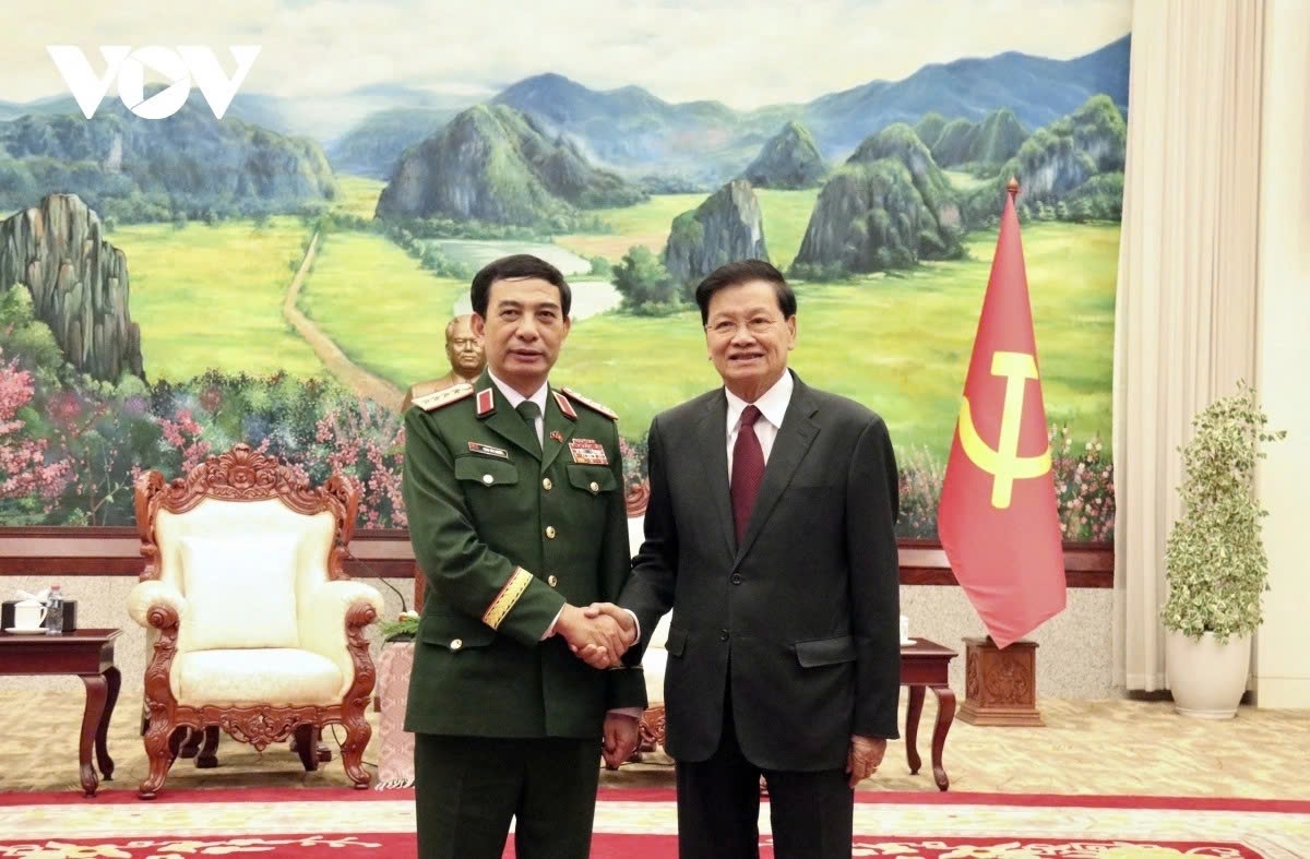 Minister of National Defence of Vietnam Phan Van Giang (L) pays a courtesy call on General Secretary and President of Laos Thongloun Sisoulith in Vientiane on October 14