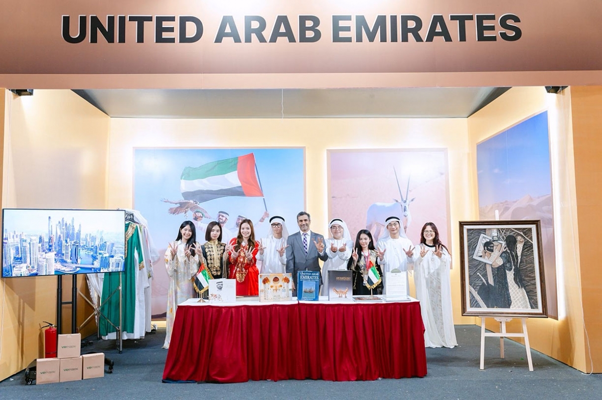 Delegates pose for a group photo at the UAE pavilion