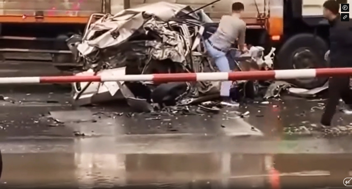 Still from the video clip shows the driver of the severely crushed car miraculously walks away unharmed after the accident