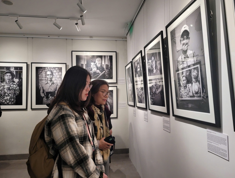 Visitors at the “Continuum: Vietnam” photo exhibition.