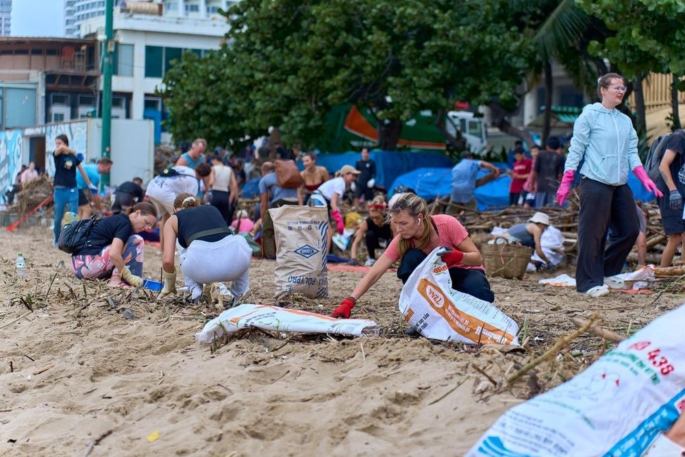 A Canadian tourist shares that seeing the shoreline covered in debris after the floods, she feels compelled to take action rather than simply stand by.