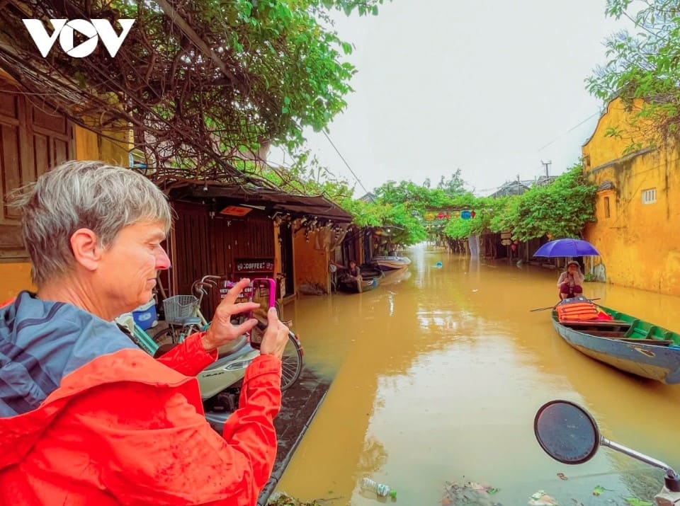 Despite widespread flooding, tourists, especially international visitors, still enjoy capturing the flood scenes