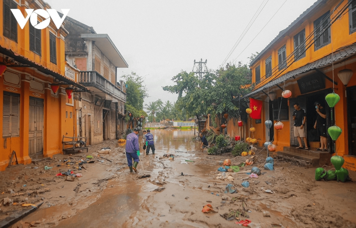 Low-lying areas of Hoi An ancient town remain flooded, with thick mud covering many old streets after the flood
