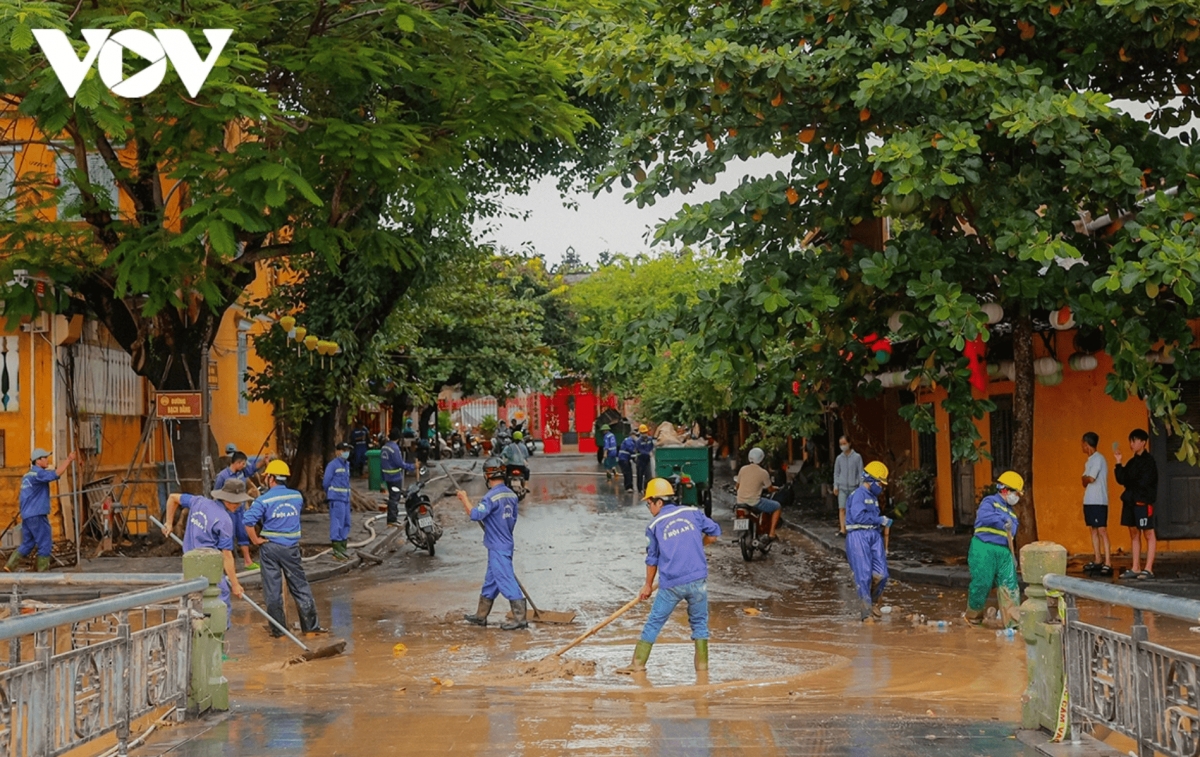 Sanitation workers clean streets in Hoi An