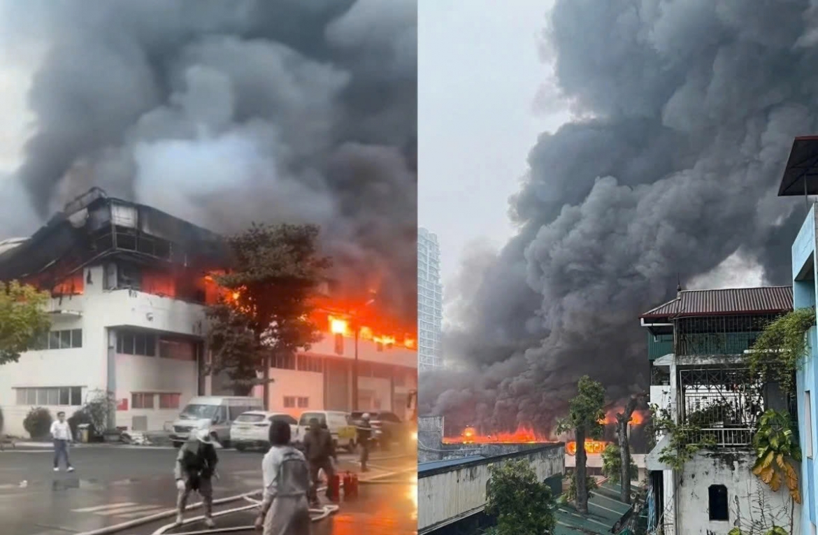 Dense black smoke rises in billows from the administrative block of the brewery during the fire