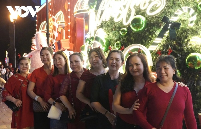 Residents dressed in Christmas-themed outfits visit and take photos