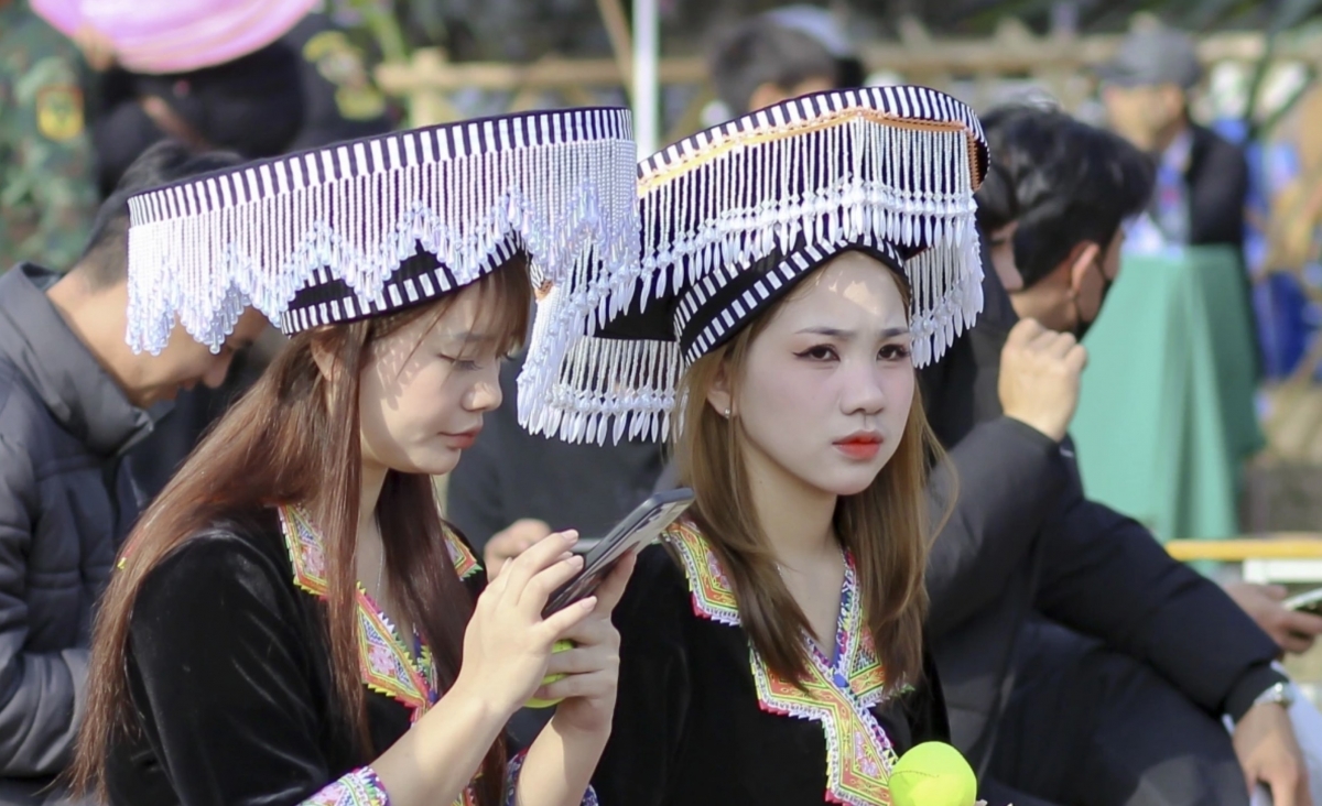 Mong girls wear colourful traditional costumes as they join the festival celebrations.