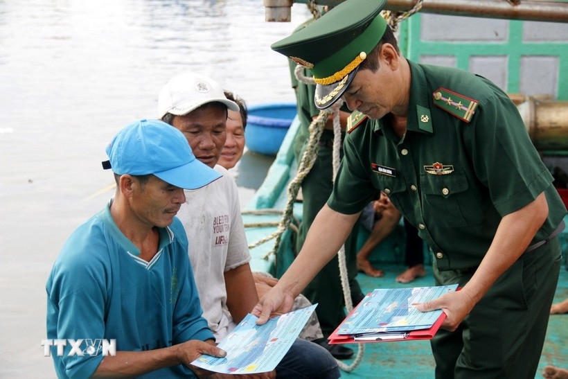 Distributing documents on anti-IUU fishing to fishermen.