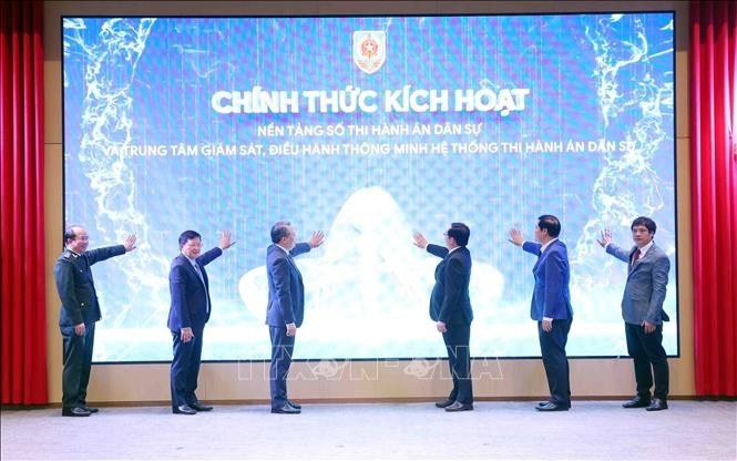Deputy Prime Minister Ho Quoc Dung (second, left) and Minister of Justice Nguyen Hai Ninh, together with other delegates, at the launch of the national digital platform for civil judgment enforcement and the intelligent operations centre for the civil judgment enforcement system (Photo: VNA)