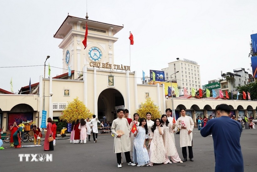Visitors pose for a photo at Ben Thanh Market in HCM City
