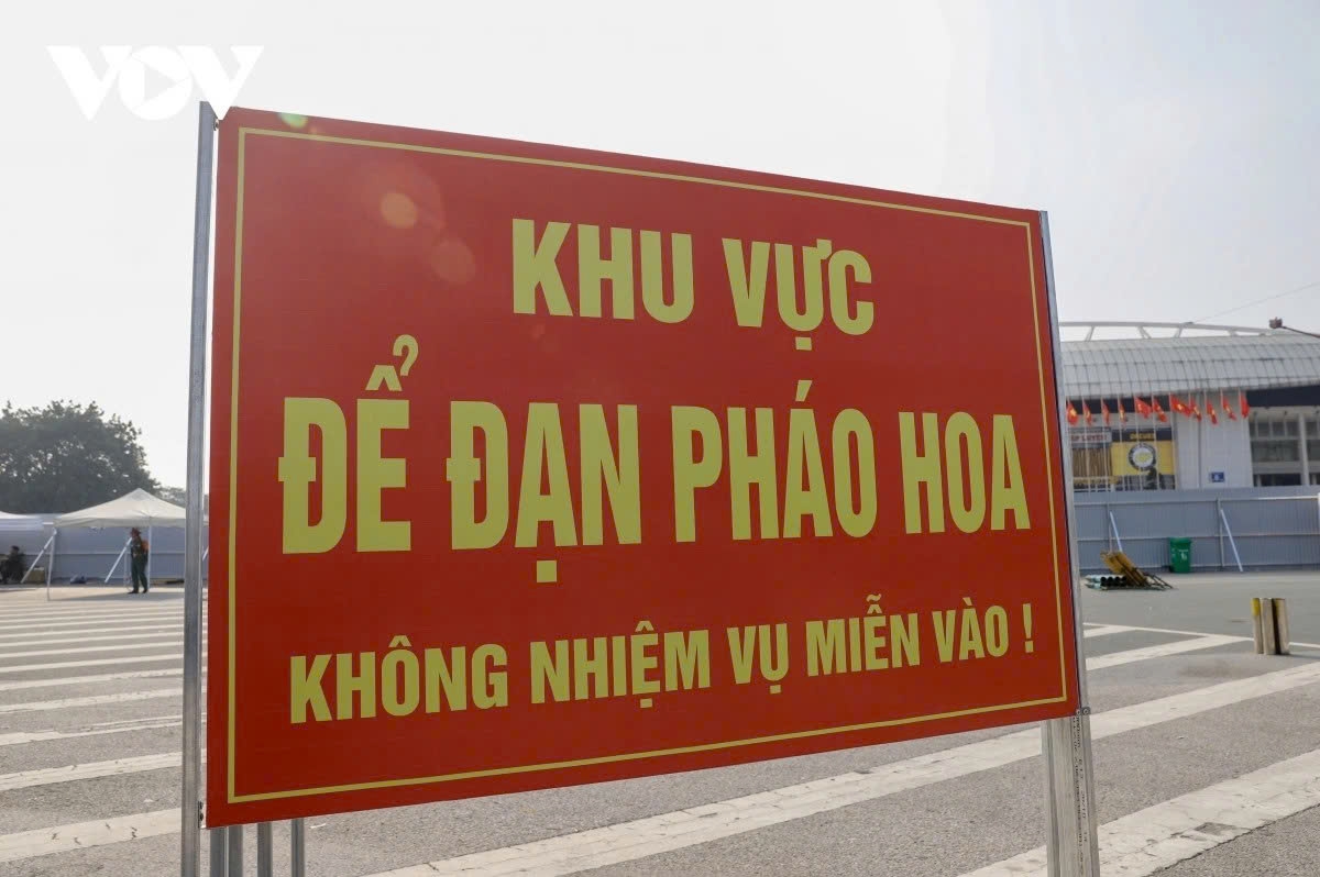 Warning signs marking fireworks installation and storage areas are set up at multiple locations around My Dinh National Stadium in Hanoi.