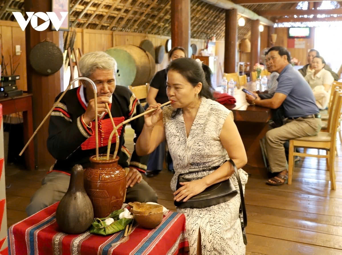 Visitors sample traditional E De rice wine as part of the cultural experience.