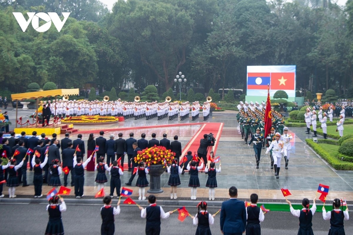 They watch a ceremonial parade of the Vietnam People’s Army.