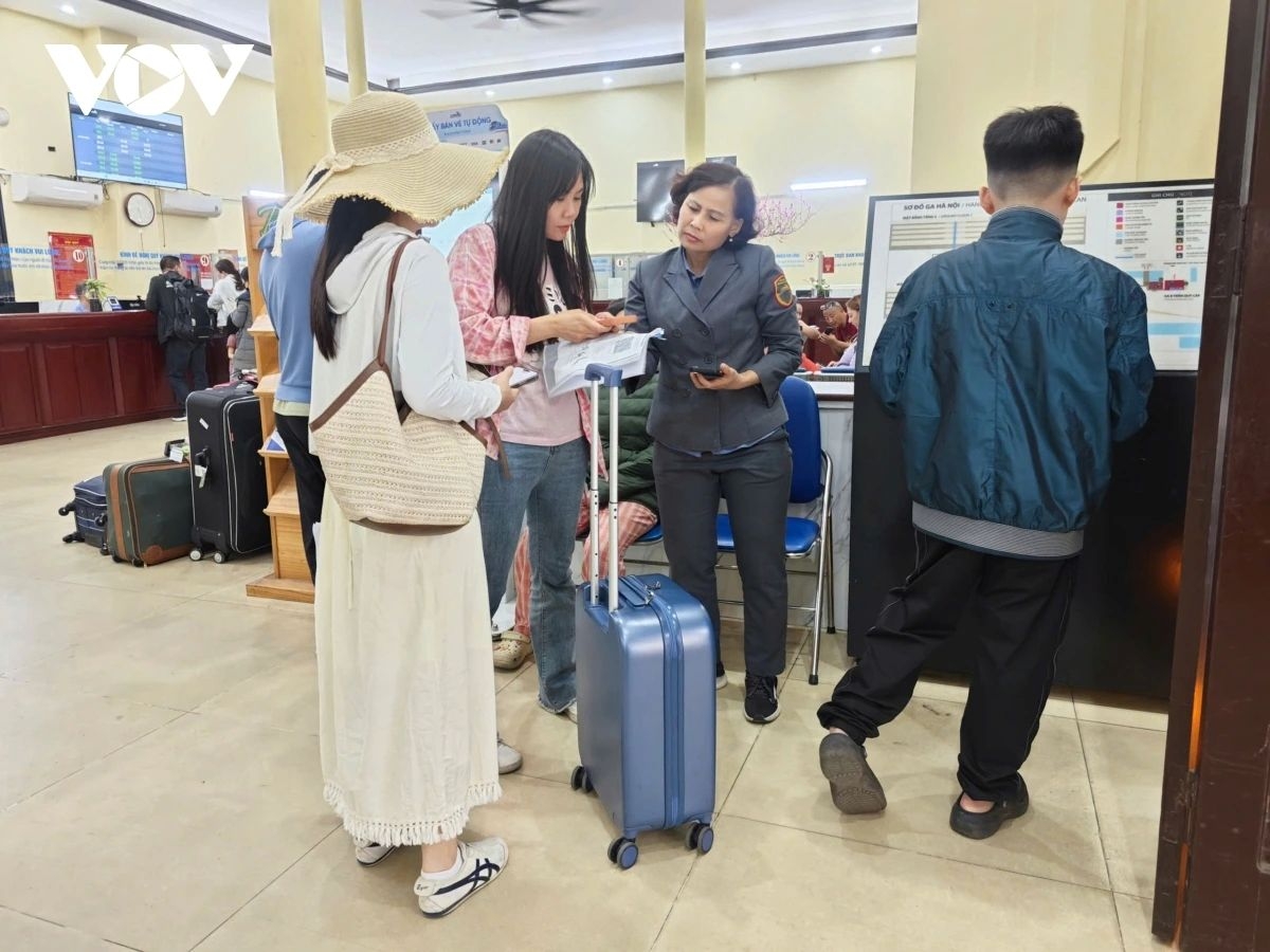 At Hanoi Railway Station, the number of foreign tourists gathering in the terminal area continues to rise. In the photo, station staff provide enthusiastic assistance and guidance to passengers.