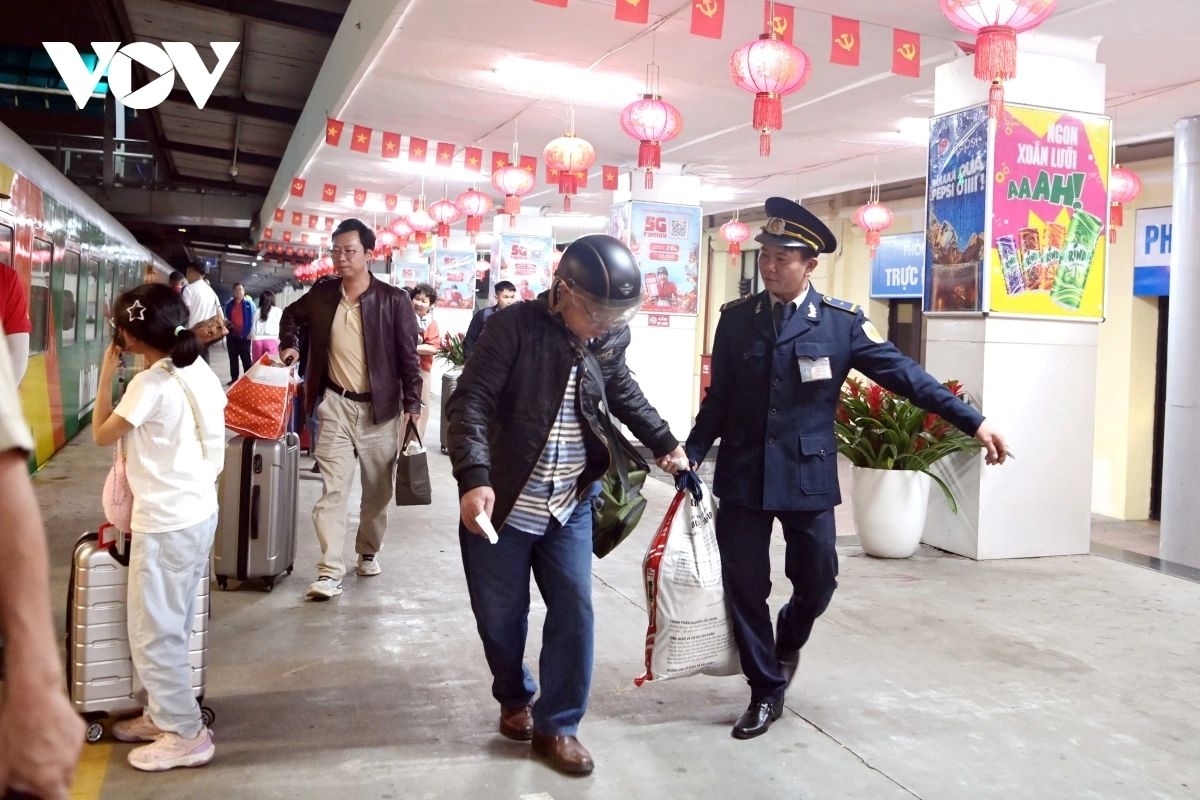 Station staff remain on duty to assist passengers with loading their luggage onto the train.