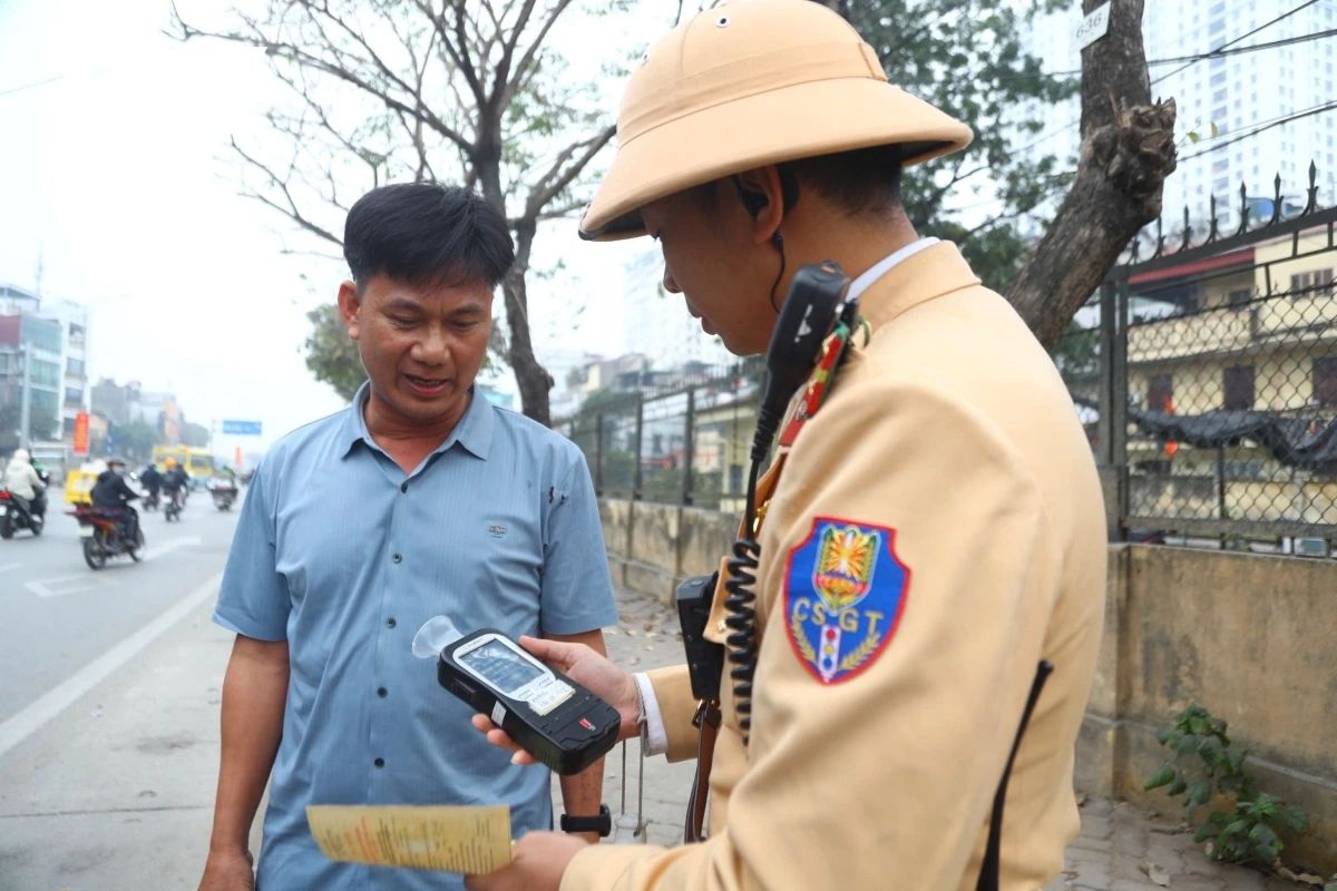 Traffic police conduct a breath alcohol test on a driver during the Lunar New Year holiday