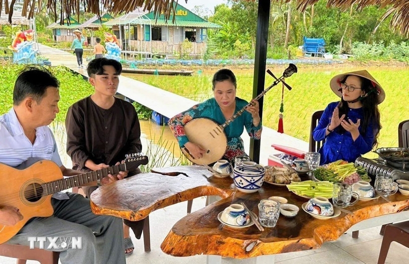 A don ca tai tu performance at the Canh Dong Cau Ba agricultural eco-tourism site, Ho Chi Minh City.