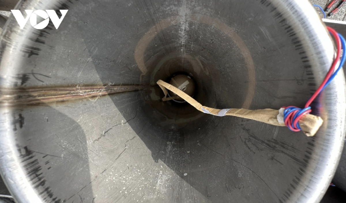 Adjusting the position of fireworks in the tubes to ensure precision.