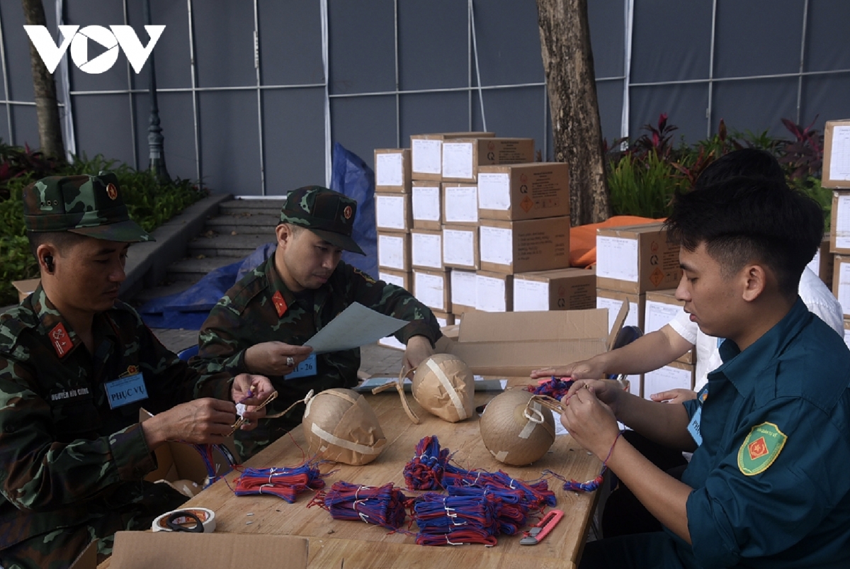Soldiers attach fuses to the fireworks.