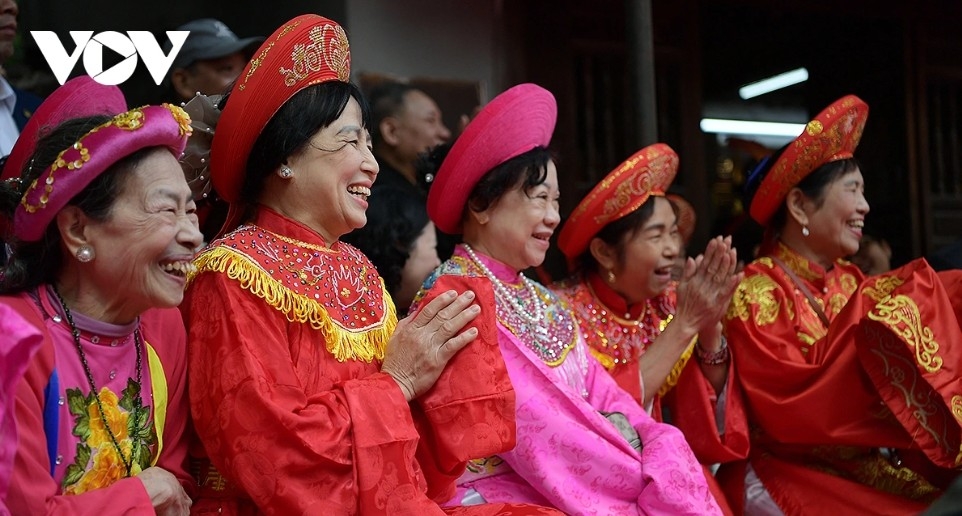 Spectators cheer enthusiastically for the wrestlers to the lively beat of festival drums.
