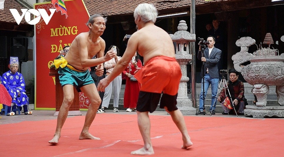 Two veteran wrestlers perform the ceremonial opening bout at the Mai Dong Traditional Wrestling Festival.
