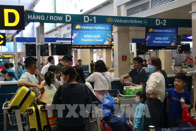 Passengers check in for their flight at Tan Son Nhat Airport.