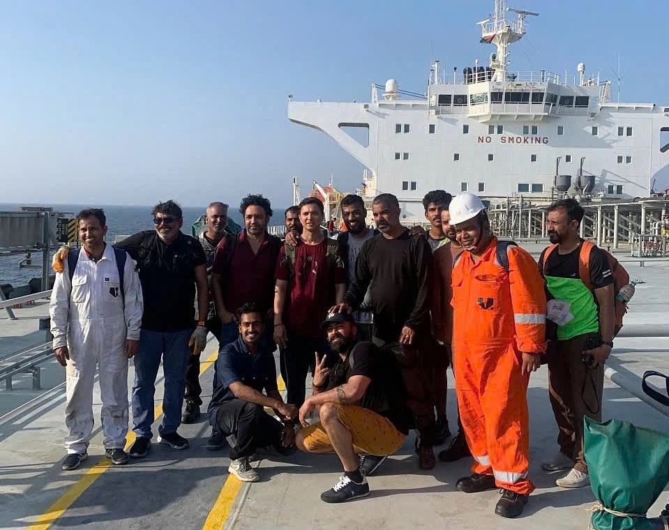 Rescued crew members of the tanker MKD VYOM before leaving the tanker SAND to go ashore. (Photo: SAND crew)
