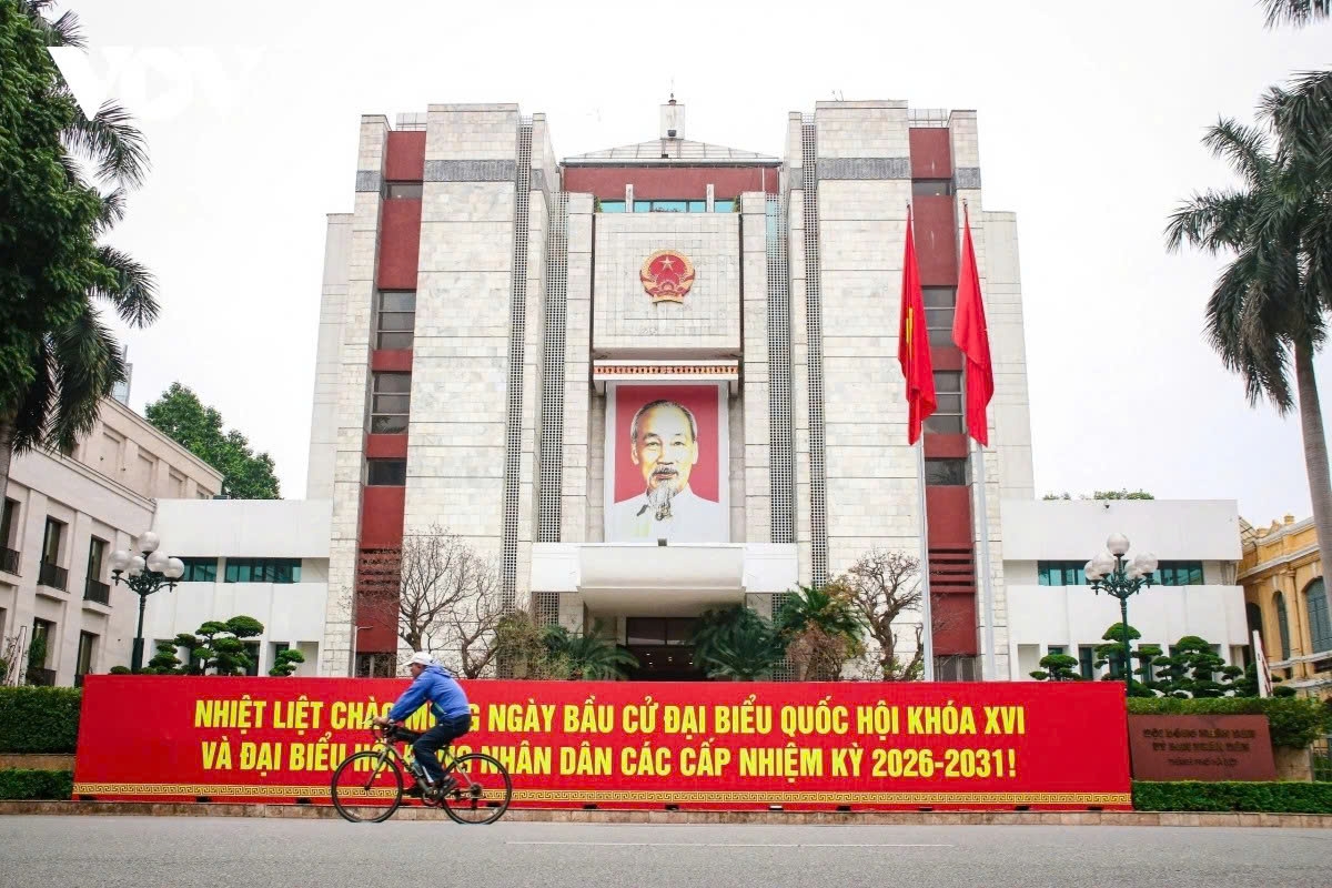 Large banners and posters are displayed in front of the headquarters of the Hanoi People’s Council and People’s Committee.
