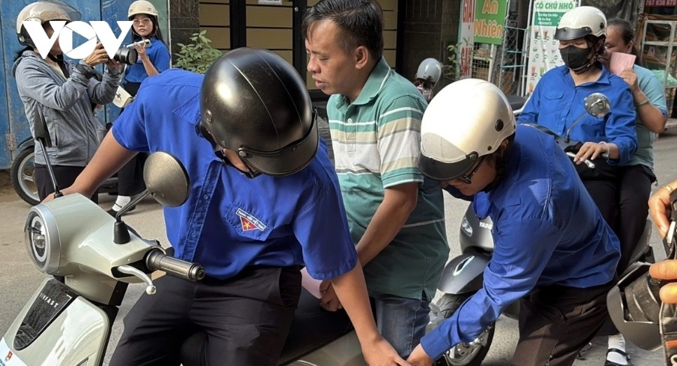 Volunteers transport visually impaired voters to a polling station.