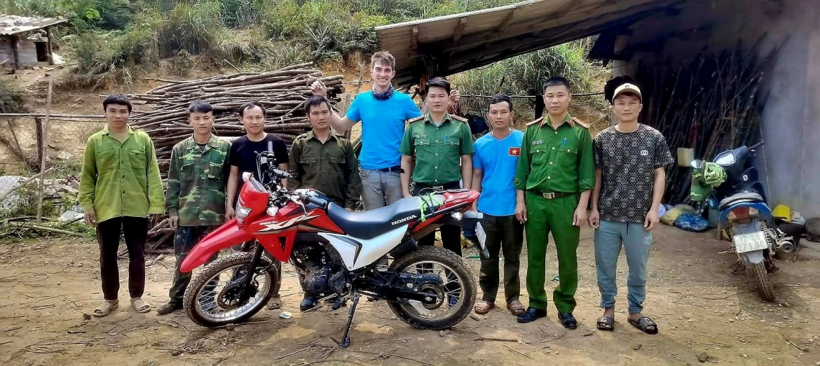 Austrian national Flo Florian poses for a group photo with local villagers and police officers, after getting lost in a forest in Lang Son province