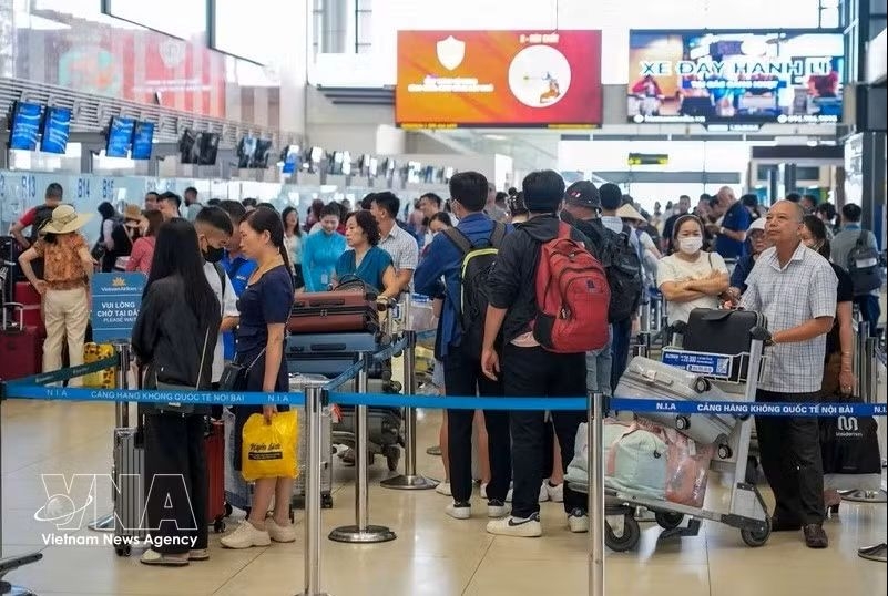 Passengers check in for flights at Noi Bai International Airport in Hanoi