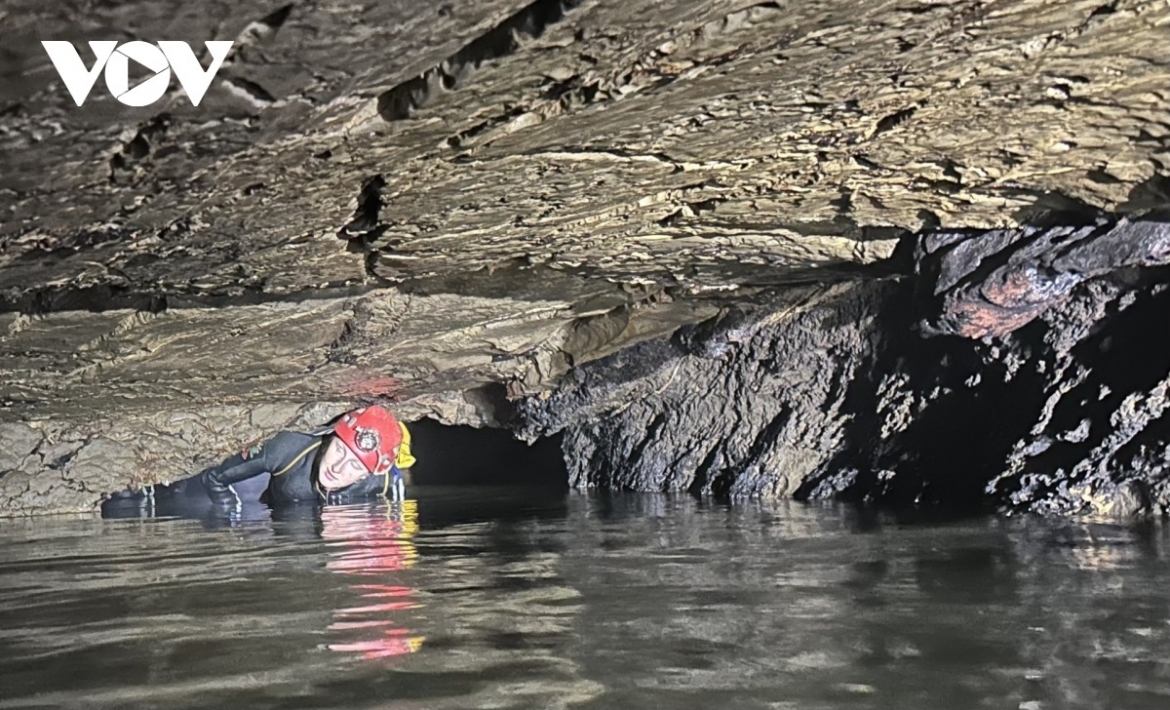 Expedition members explore Ma Dom Cave.