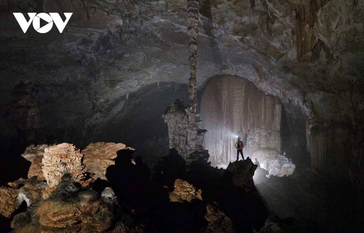 Expedition members explore Thien Cung Cave.