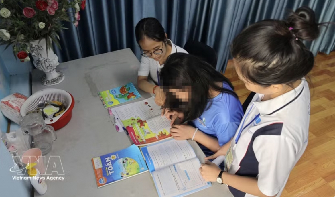 Social workers assist T.A.T. (born in 2013) with studying and daily activities at the temporary shelter of the “Bo Cong Anh” model in Hanh Thong ward, Ho Chi Minh City.