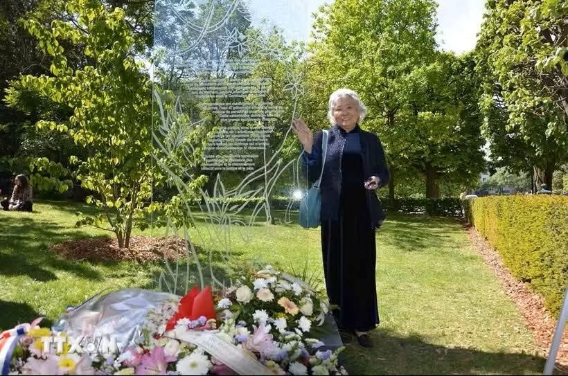 Tran To Nga at the memorial stele dedicated to victims of Agent Orange/Dioxin at Choisy Park in Paris