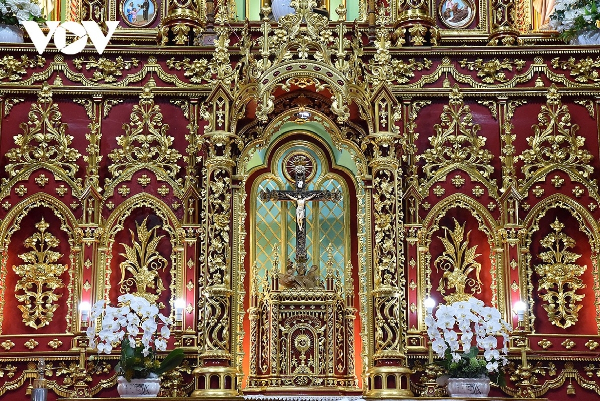 Red lacquer and gold leaf catch the light, filling the interior with a warm, shimmering glow.