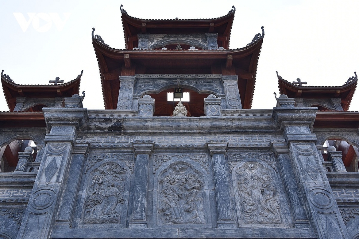 Upturned roof finials inspired by traditional Vietnamese communal houses and pagodas blend seamlessly with Gothic elements, creating a distinctive architectural fusion.