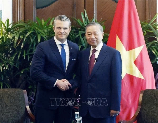 Vietnam's Party General Secretary and State President To Lam (R) and US Defence Secretary Pete Hegseth meet on the sidelines of the 23rd Shangri-La Dialogue in Singapore on May 29