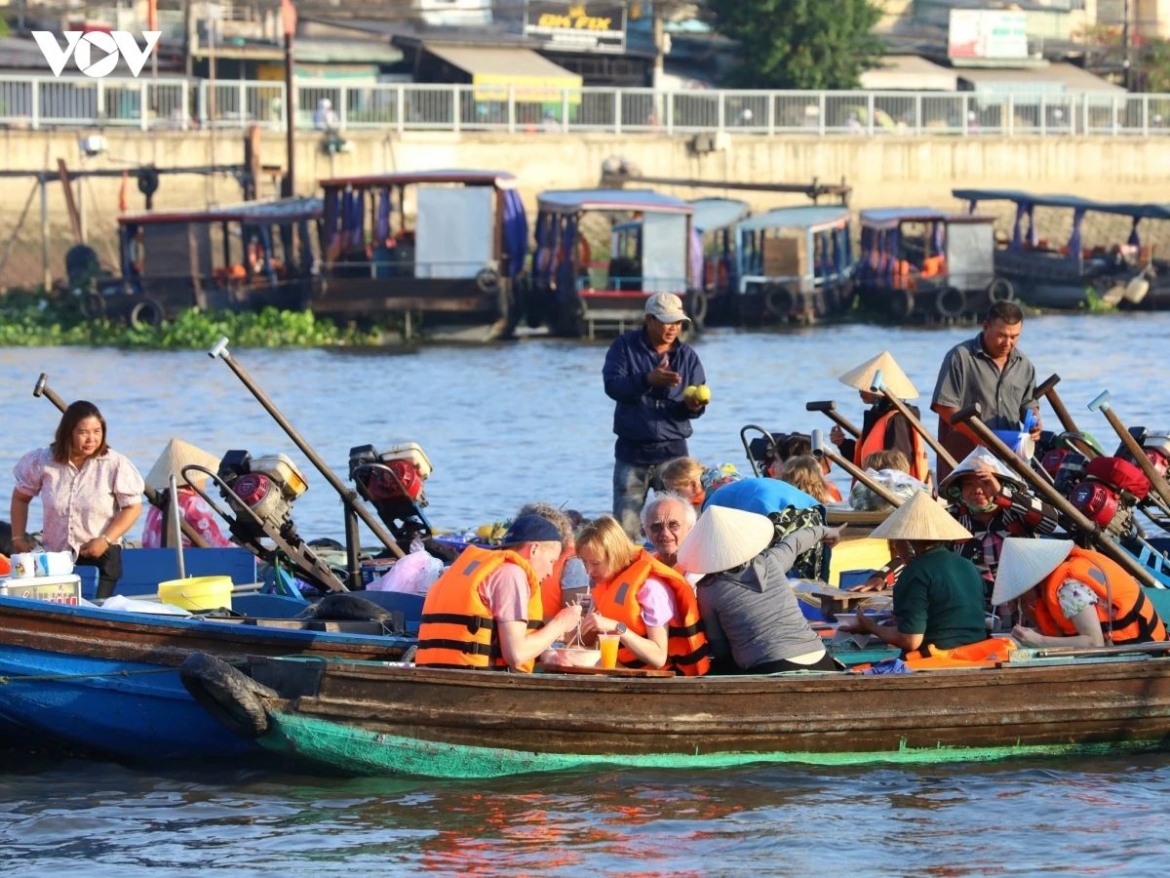International tourists enjoy a boat tour in Can Tho City
