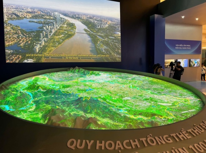 Organisers project a map of Hanoi’s 100-year capital master plan