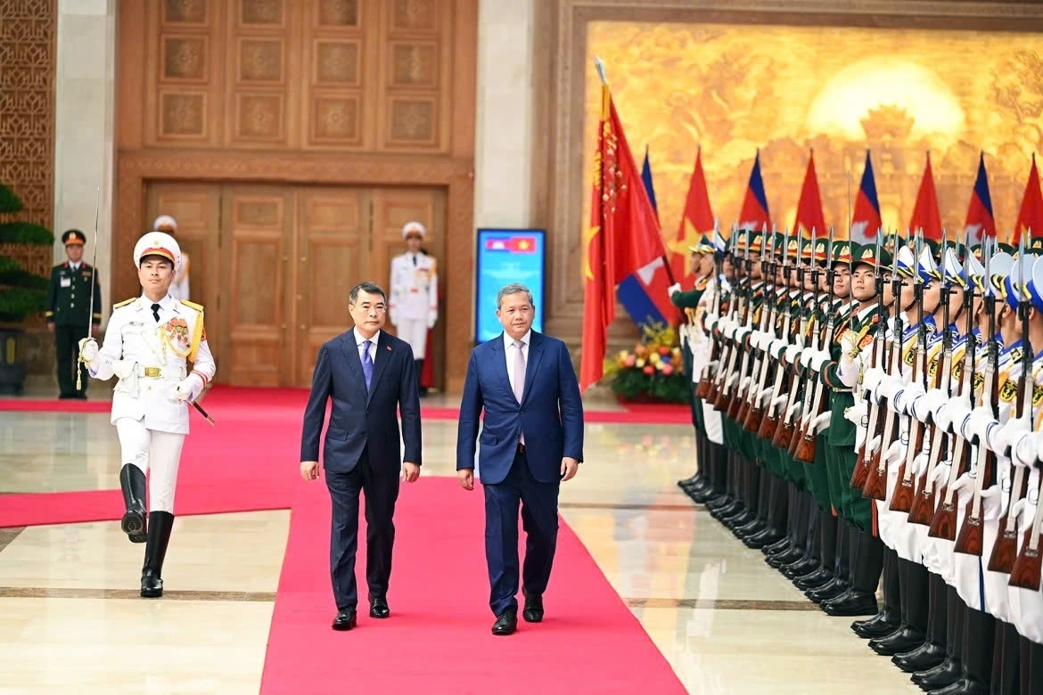 Vietnamese Prime Minister Le Minh Hung (L) and Cambodian Prime Minister Hun Manet review the guard of honour in Hanoi on June 8