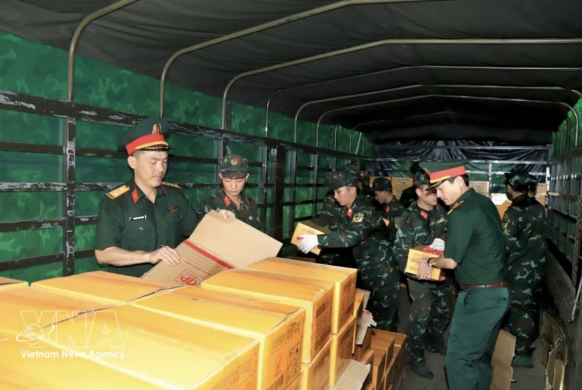 Logistics and technical personnel transport relief supplies, food and essential provisions for shipment to Venezuela