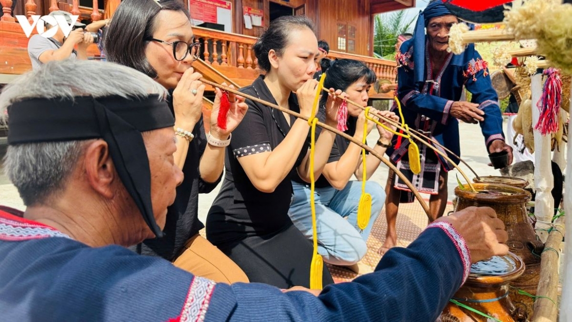 Visitors and villagers share traditional rice wine during the Ba Na harvest blessing ceremony